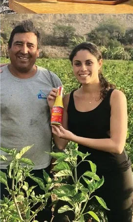 Antoinette with a Peruvian pepper farmer in the field